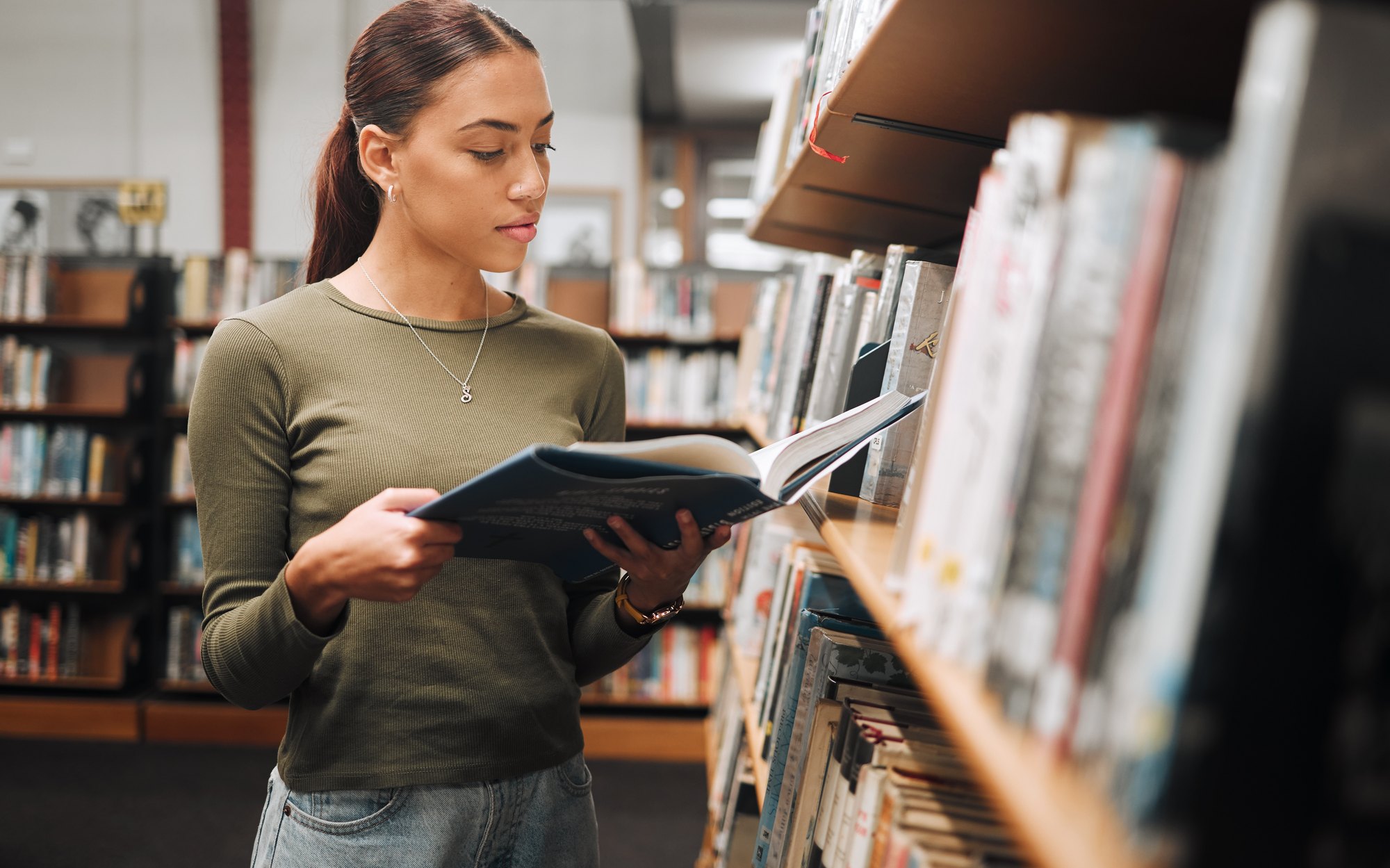 A student at the library shelves