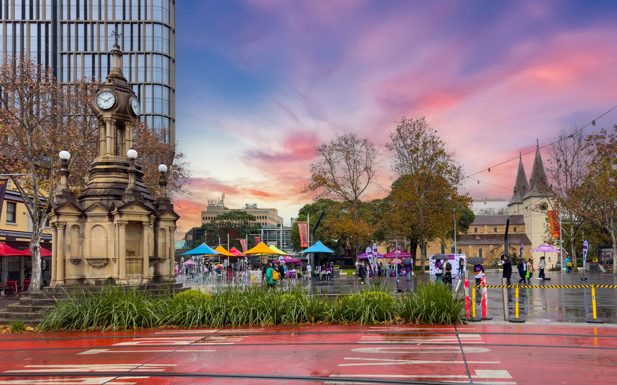 Parramatta Square at dusk, with the Centenary clock tower and St John's Cathedral